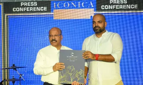 Project promoters K Murali Krishna and K Santosh unveiling a brochure in Visakhapatnam on Sunday