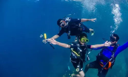 Young female diver from city leads underwater habitat restoration