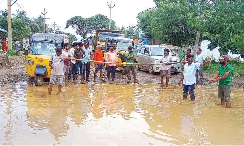 Fill up potholes on BN Road, locals demand