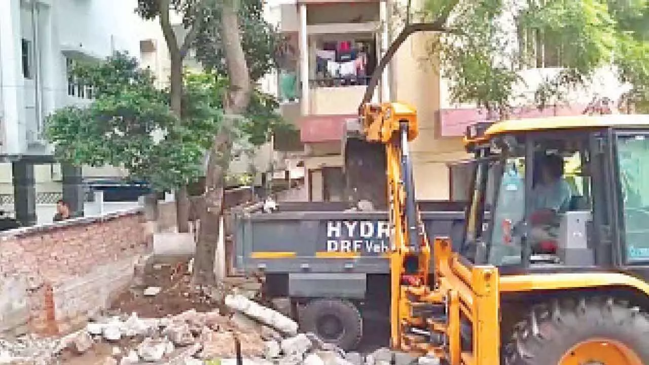 Residents hail HYDRAA’s razing of Habsiguda barrier wall Residents hail HYDRAA’s razing of Habsiguda barrier wall