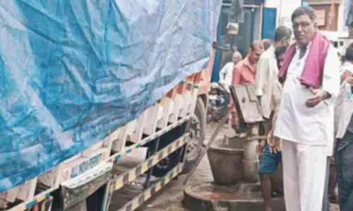 Mini lorry gets stuck in damaged drain