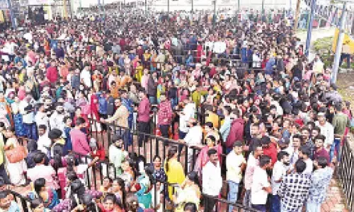 Union Minister Karandlaje walks up the steps for Ashada Friday darshan