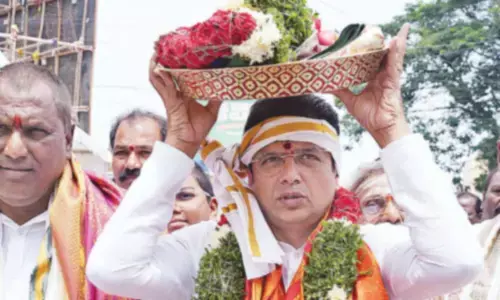 Ministers offer silk clothes to deity