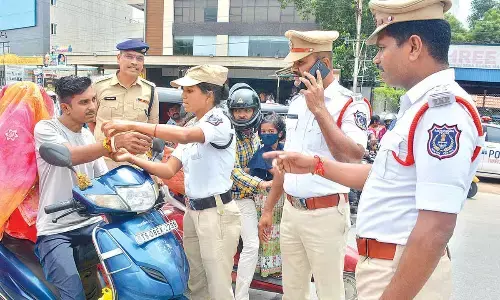 Traffic police tie rakhis to helmetless drivers