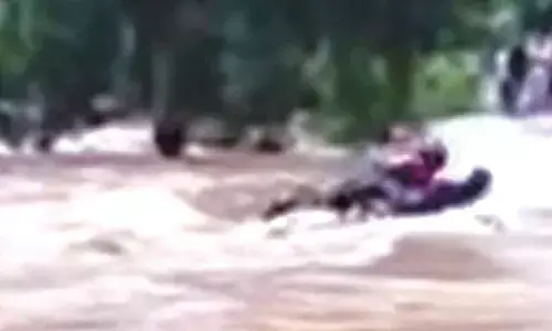 3 rescued after being swept away in floodwater