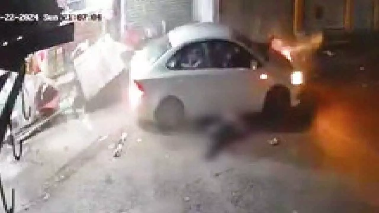 Man held for running over 2 men on his car Man held for running over 2 men on his car