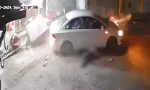 Man held for running over 2 men on his car Man held for running over 2 men on his car