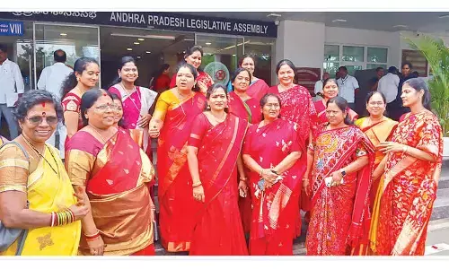 Women ministers, members wear red saris