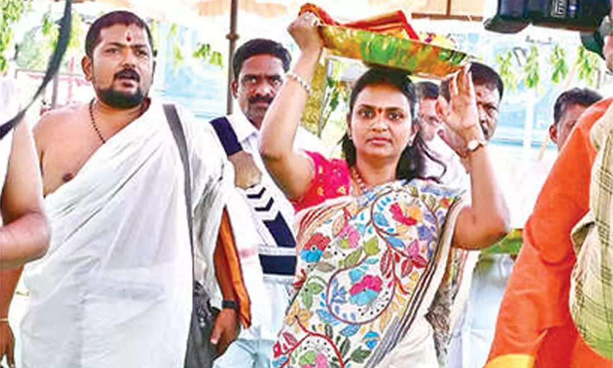 Collector presents silk garments to Goddess Jogulamba and Lord Balabrahmeswara