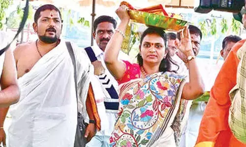 Collector presents silk garments to Goddess Jogulamba and Lord Balabrahmeswara