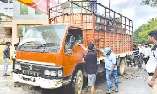 Liquor truck catches fire; crowd gathers to grab bottles