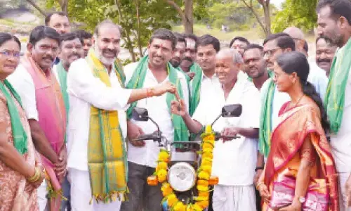 Keeping his words, Aadi Srinivas gifts bike to loyal supporter