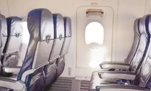 Passenger detained for trying to open emergency exit on flight