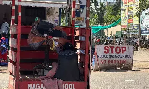 Homeless Woman Takes Refuge Under Traffic Sign in Nagarkurnool