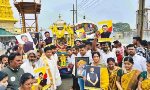 DKS supporters pull silver chariot at Chamundi Hills