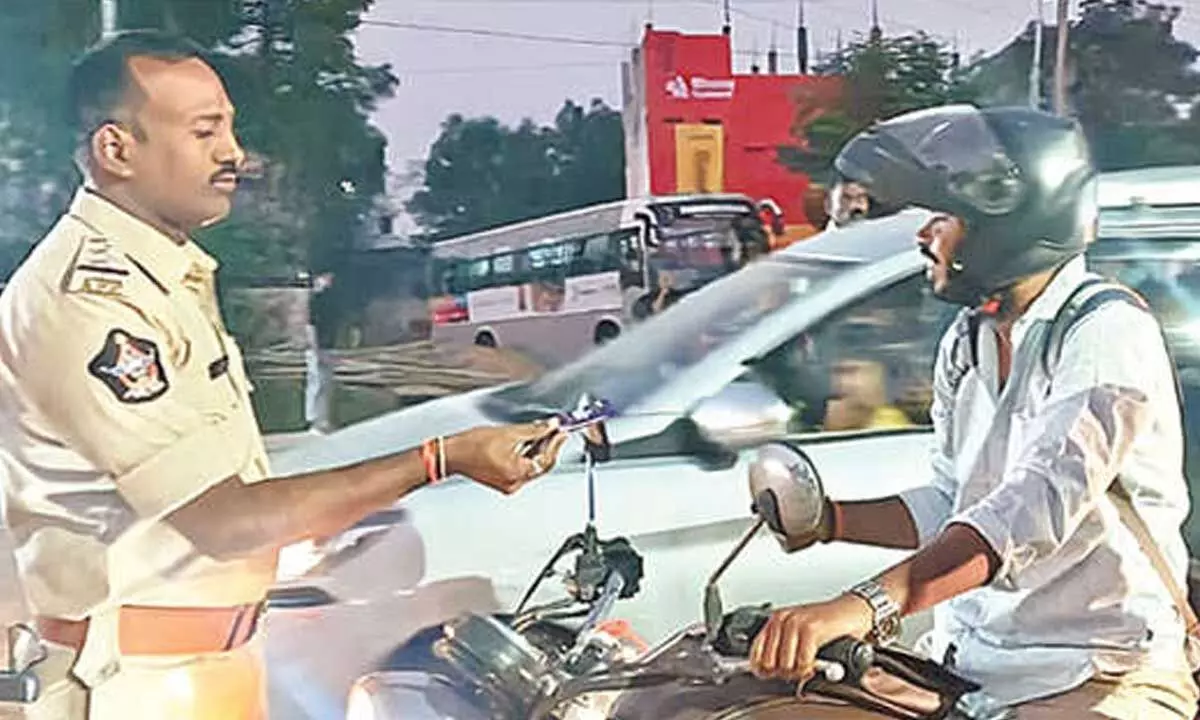 Chocolates, not fines: Tirupati Police promote helmet safety Chocolates, not fines: Tirupati Police promote helmet safety