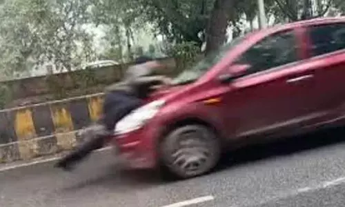 Traffic cop dragged on car bonnet; driver held