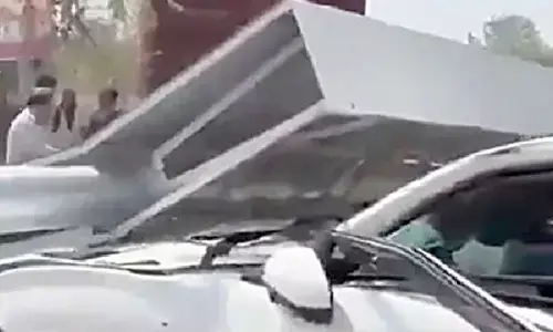 Man dies as signboard pole falls on moving car