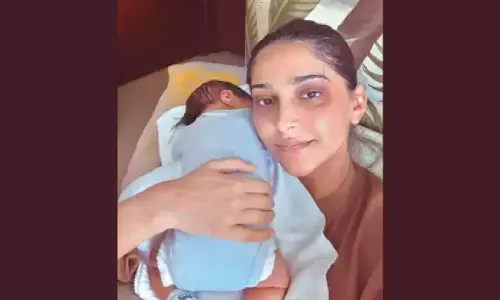 Sonam Kapoor flaunts her dark circles as she lovingly holds her newborn son