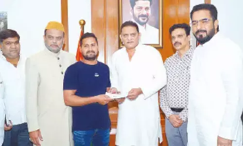 Minority Welfare Minister Mohammed Azharuddin, AIMIM MLA Mohammed Majid Hussain and State Haj Committee Chairman Khusro Pasha distribute ex-gratia cheques to the families of victims who lost their lives in the Madina bus tragedy in Saudi Arabia, at the Secretariat in Hyderabad on Wednesday