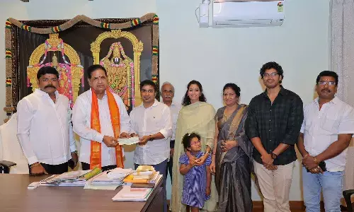 Hyderabad-based devotee Chevuri Ushasri family members handing over the cheque to TTD chairman BR Naidu in Tirumala on Sunday