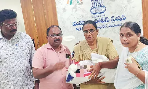 Vijayawada Women Police Station Inspector Vasavi, Village Revenue Officers (VROs) and a woman police constable with the rescued three-day-old baby girl after busting an alleged illegal infant sale racket in Vijayawada on Sunday