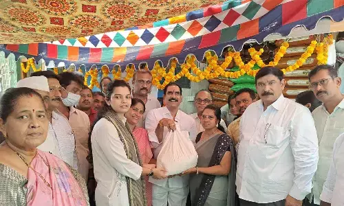 Visakhapatnam District in-charge Collector Gobbilla Vidyadhari and North MLA P Vishnu Kumar Raju distributing rice in Visakhapatnam on Monday