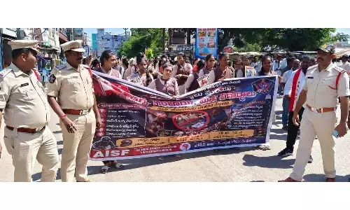 SDPO Narasimha Murthy leading college students during a police awareness rally against drugs, cyber crimes, and offences against women in Srikalahasti on Monday