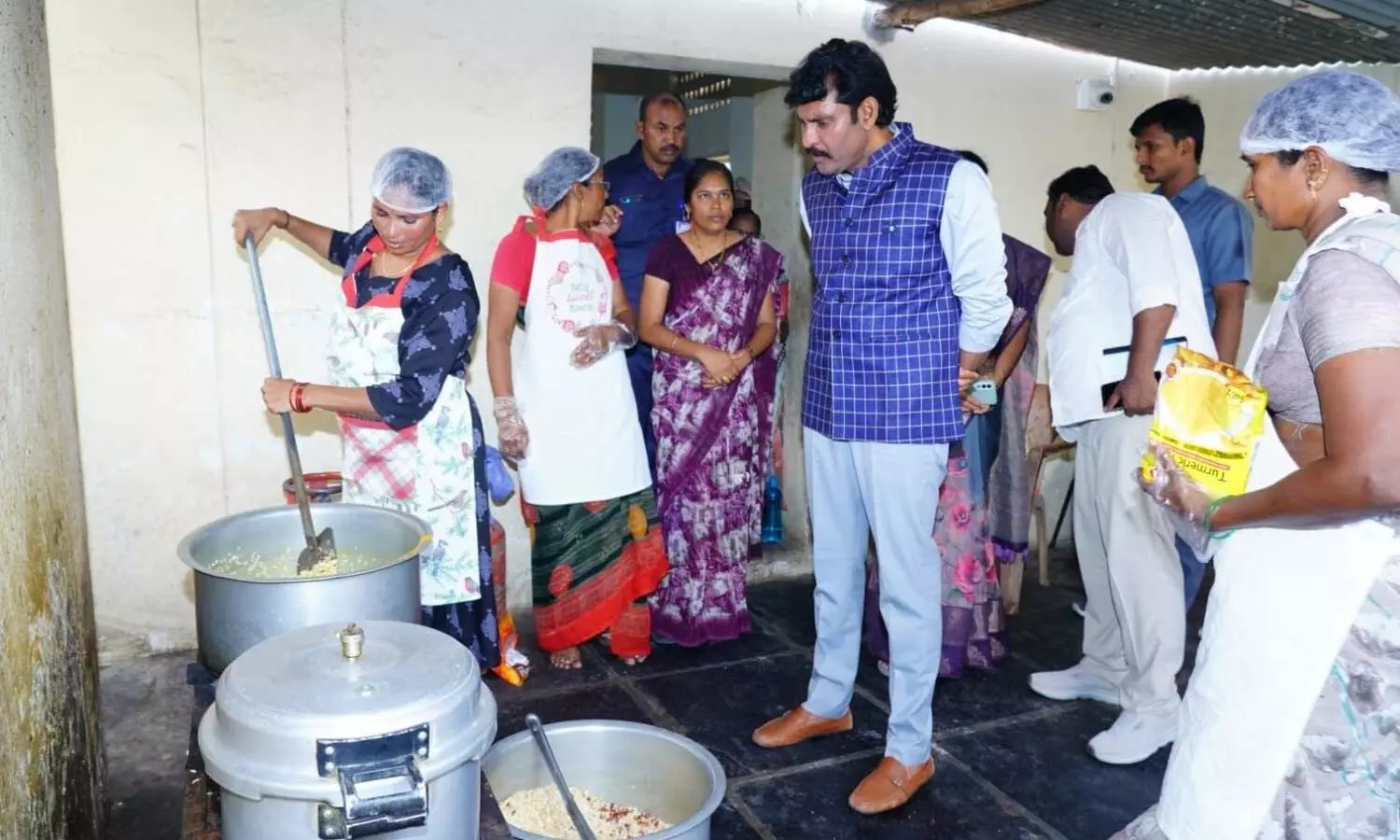 AP Food Commission Chairman Chintha Vijay Prathap Reddy inspecting food preparation at a school in Marripudi mandal on Tuesday AP Food Commission Chairman Chintha Vijay Prathap Reddy inspecting food preparation at a school in Marripudi mandal on Tuesday