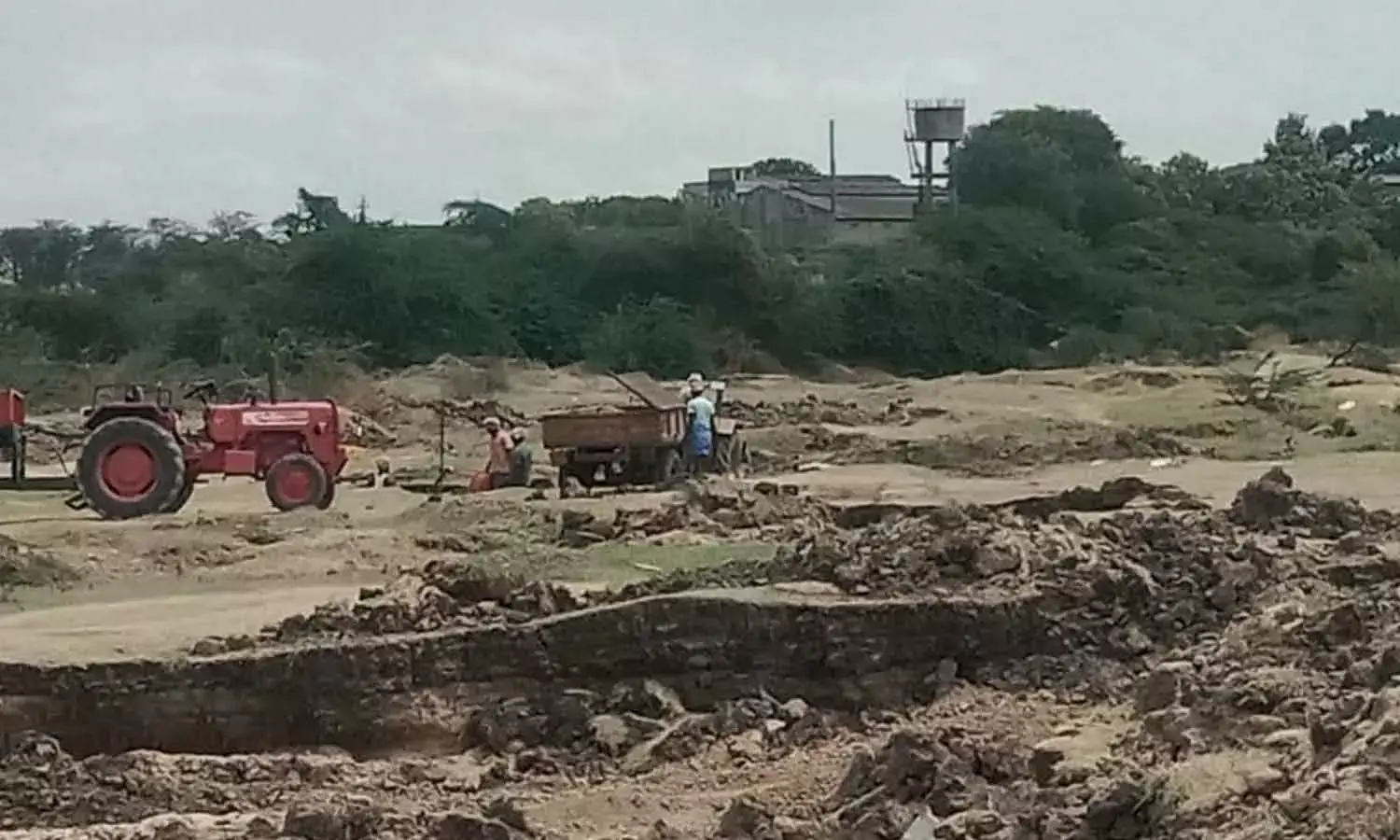 Tractors were seen loading sand from the River Tungabhadra on Thursday Tractors were seen loading sand from the River Tungabhadra on Thursday