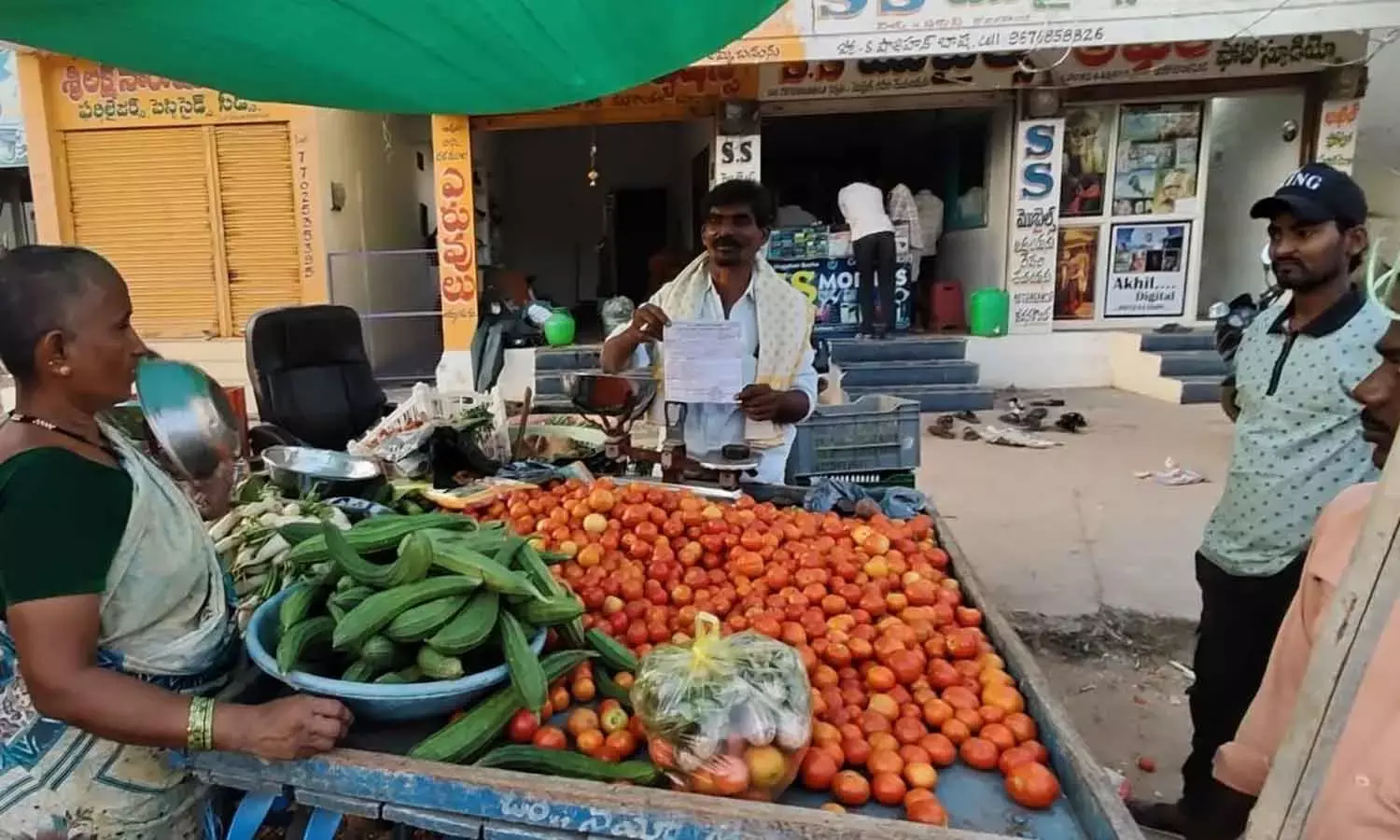 Officials of Legal Metrology department imposing penalty on petty vendors at Devanakonda on Saturday Officials of Legal Metrology department imposing penalty on petty vendors at Devanakonda on Saturday