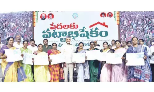 Chief Minister N Chandrababu Naidu with the beneficiaries at the ownership deed distribution programme in Visakhapatnam on Saturday Chief Minister N Chandrababu Naidu with the beneficiaries at the ownership deed distribution programme in Visakhapatnam on Saturday