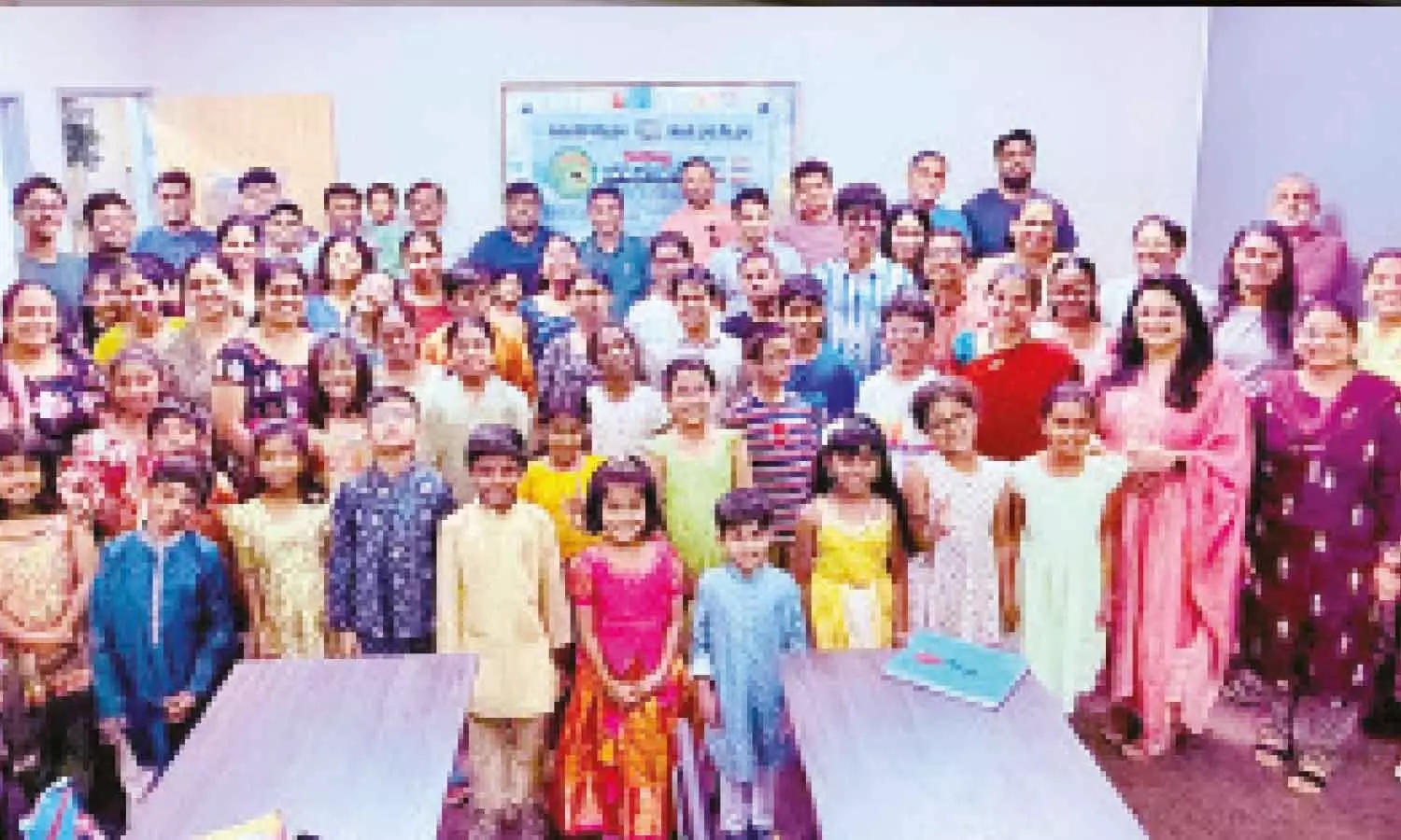 Teachers, community members, and students pose together indoors as ManaBadi centers celebrate two decades of promoting Telugu language education and cultural heritage Teachers, community members, and students pose together indoors as ManaBadi centers celebrate two decades of promoting Telugu language education and cultural heritage