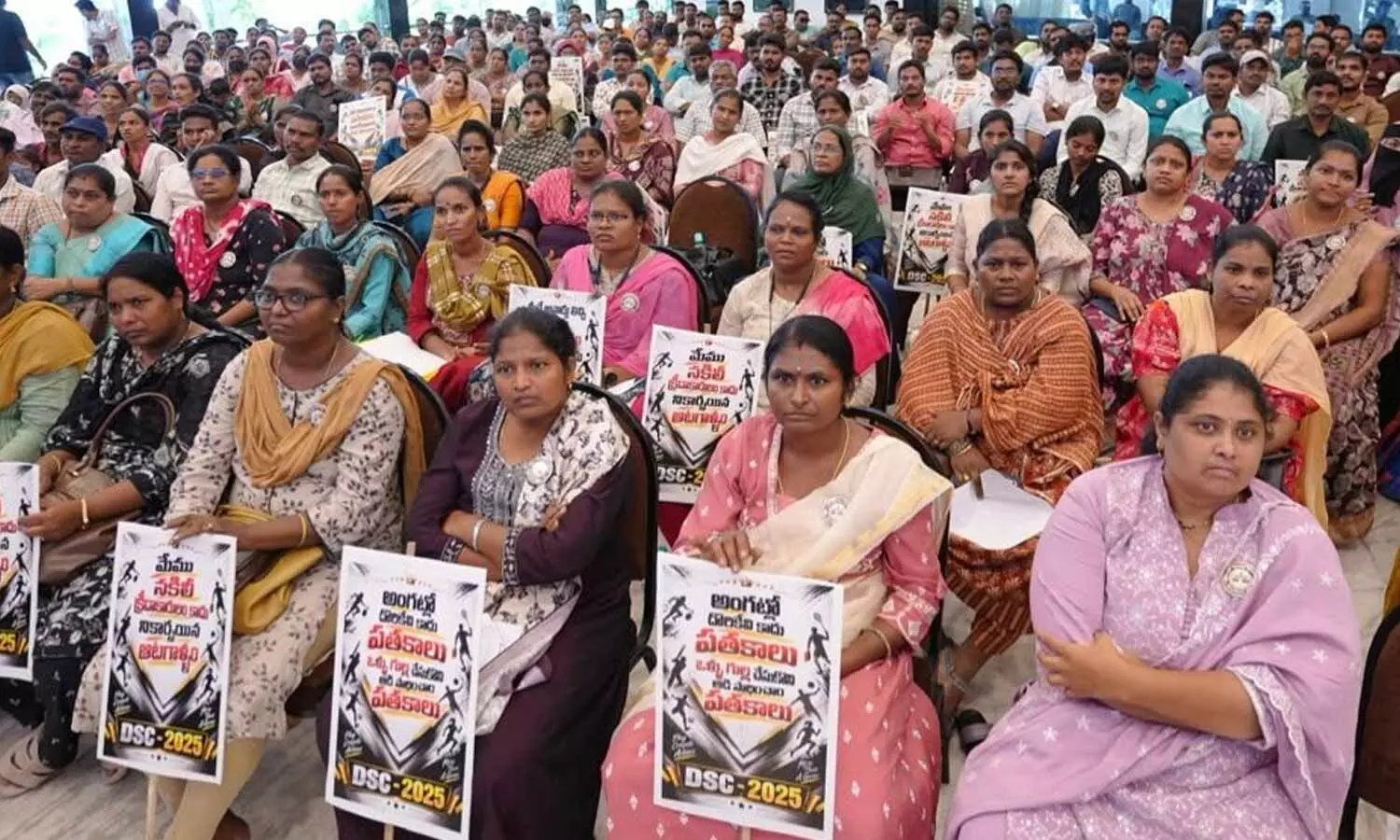 Teachers showing placards during a round table meeting in Vijayawada on Sunday Teachers showing placards during a round table meeting in Vijayawada on Sunday