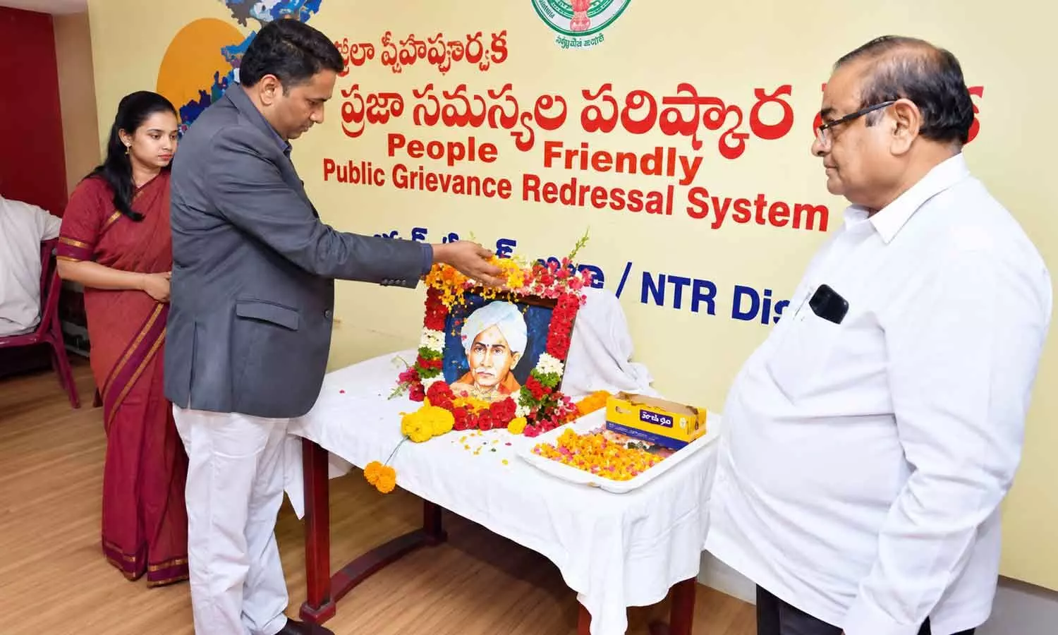 Collector Dr G Lakshmisha paying floral tributes to Gurajada Venkata Apparao at the Collectorate in Vijayawada on Monday Collector Dr G Lakshmisha paying floral tributes to Gurajada Venkata Apparao at the Collectorate in Vijayawada on Monday