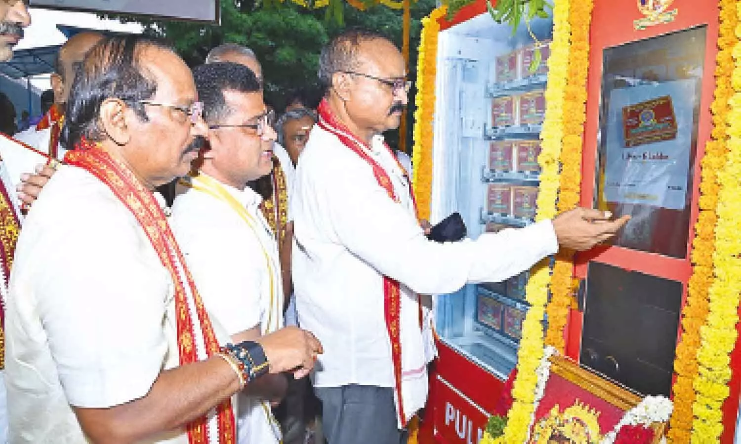 Endowments Commissioner K Ramachandra Mohan scans the UPI code to collect laddu prasadam from the automated vending machine after launching it atop Indrakeeladri in Vijayawada on Wednesday Endowments Commissioner K Ramachandra Mohan scans the UPI code to collect laddu prasadam from the automated vending machine after launching it atop Indrakeeladri in Vijayawada on Wednesday