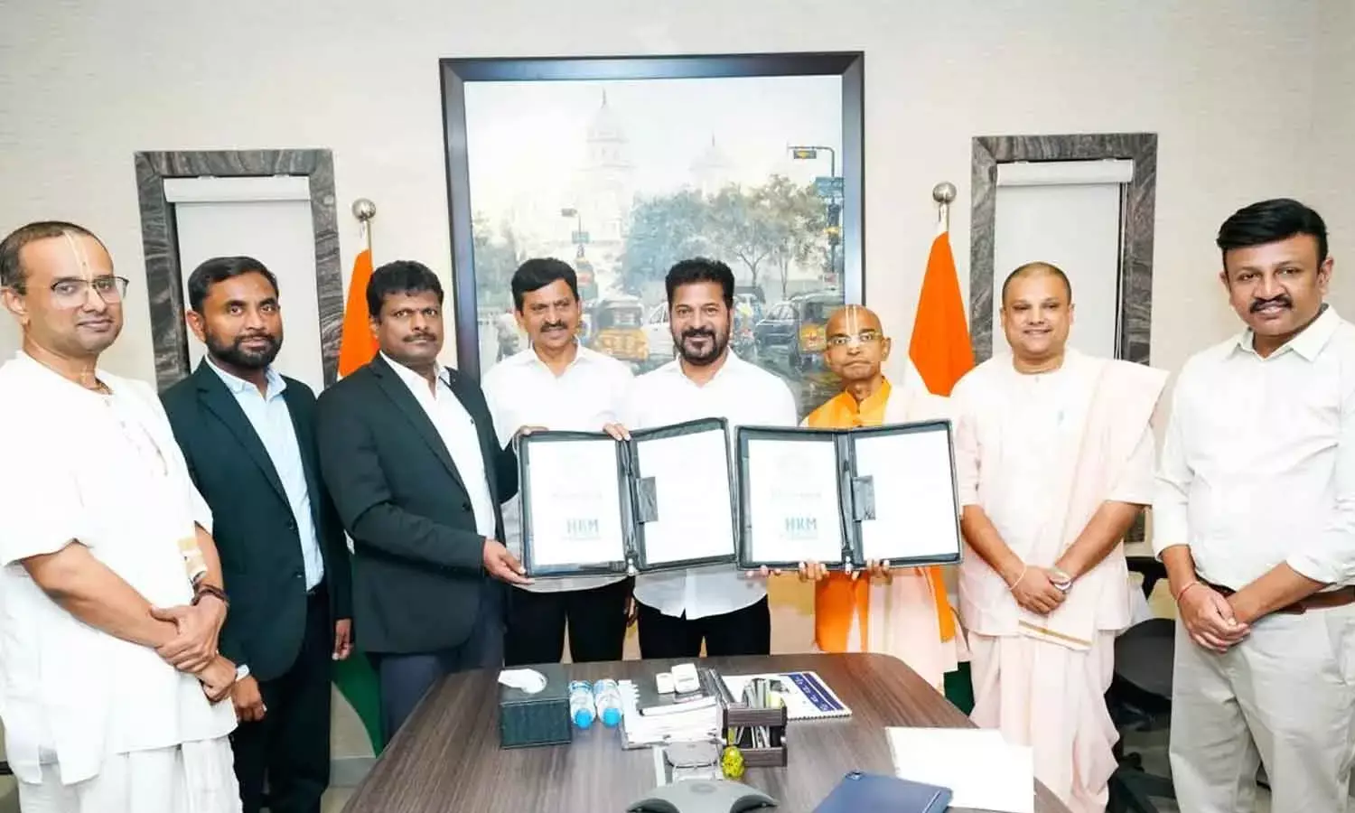 Representatives of Junna Solar Systems and Chain Labs India sign agreements with Hare Krishna Foundation to implement  breakfast scheme for students in government schools, in the presence of Chief Minister A Revanth Reddy in Hyderabad on Friday
