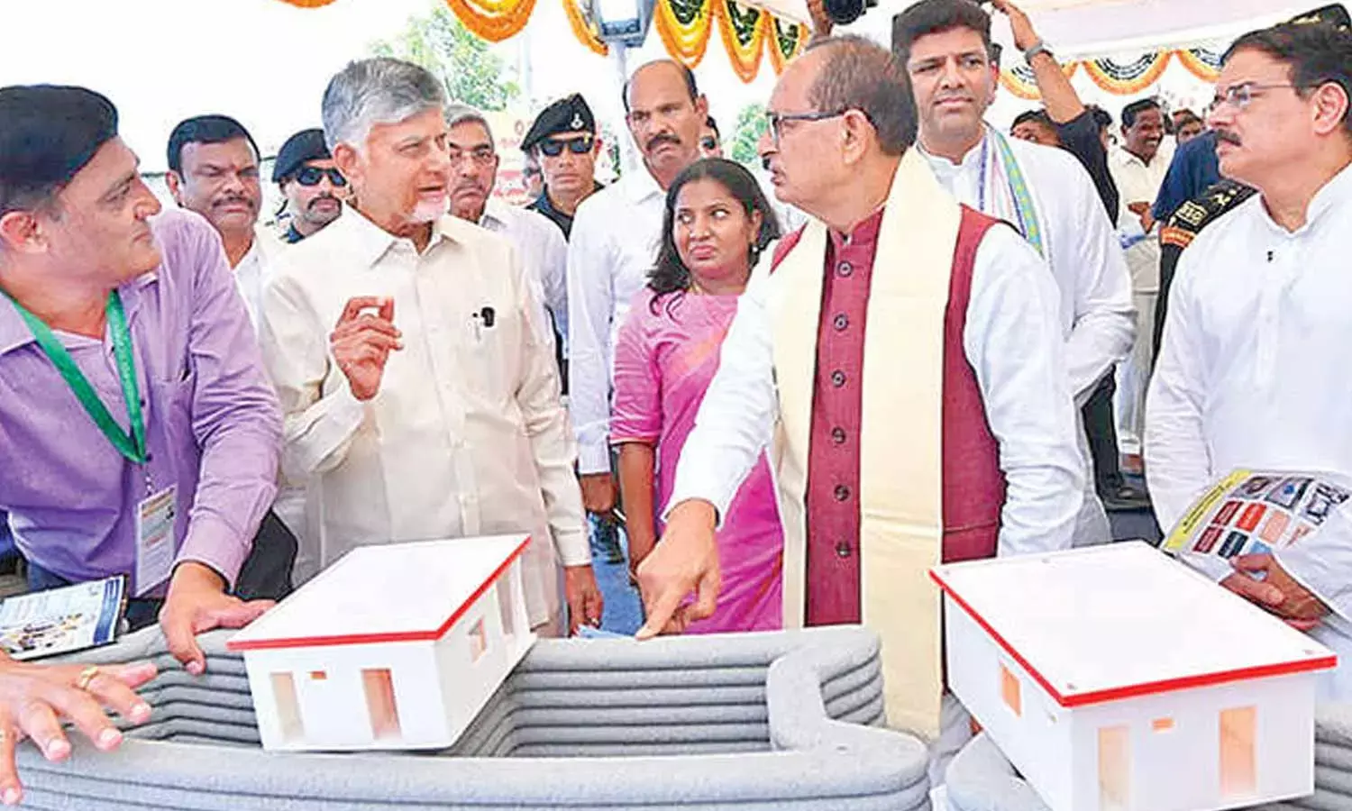 Chief Minister N Chandrababu Naidu explaining about 3D concrete printing technology for housing to Union Minister Shivraj Singh Chouhan at foundation laying ceremony for 3 lakh houses across state at Burripalem village in Guntur district on Sunday Chief Minister N Chandrababu Naidu explaining about 3D concrete printing technology for housing to Union Minister Shivraj Singh Chouhan at foundation laying ceremony for 3 lakh houses across state at Burripalem village in Guntur district on Sunday
