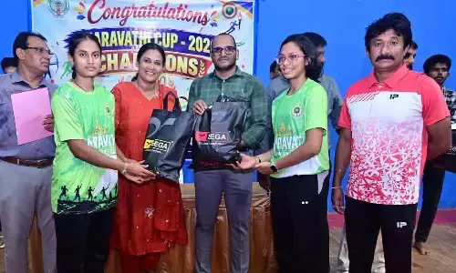 Collector MN Harendhira Prasad, along with Olympian K Rajini distributing tracksuits and sports shoes to sportspersons at the Sports Authority office on Thursday