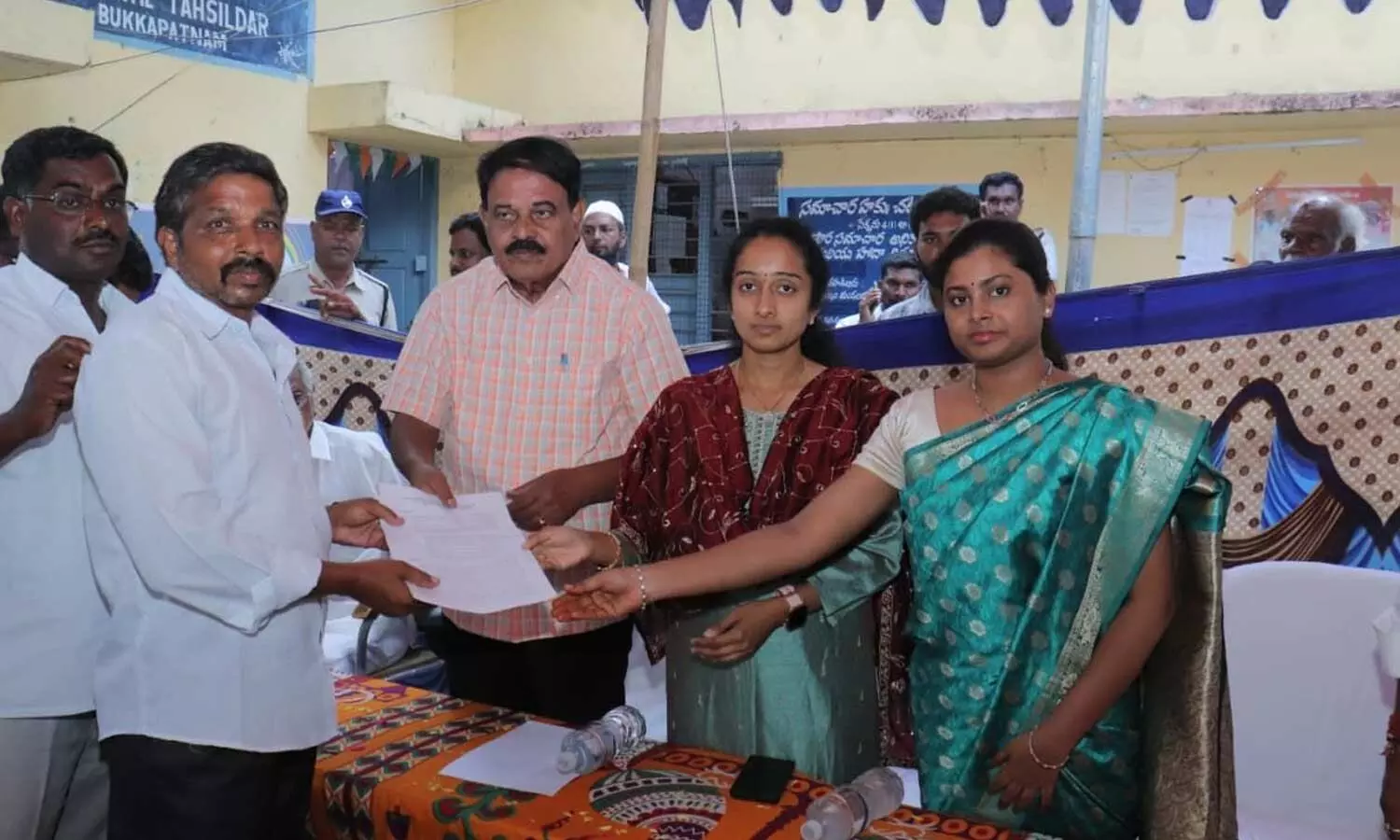 MLA Palle Sindhura Reddy and former Minister Dr Palle Raghunatha Reddy distributing land rights documents to Krishnapuram farmers on Friday MLA Palle Sindhura Reddy and former Minister Dr Palle Raghunatha Reddy distributing land rights documents to Krishnapuram farmers on Friday