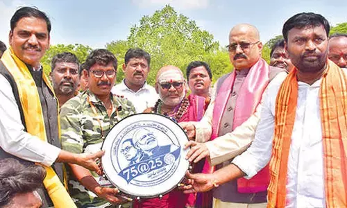 BJP leaders distributing Dappu to an artist in Tirupati on Sunday BJP leaders distributing Dappu to an artist in Tirupati on Sunday