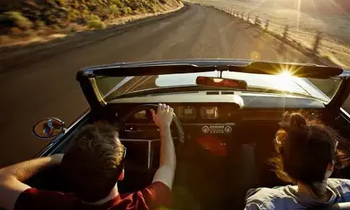 Why must foreign travelers hire a local driver rather than self-drive the car?