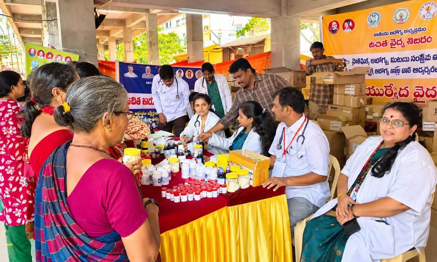 Doctors providing free Ayurvedic medical services to devotees at the camp organised in Vijayawada Doctors providing free Ayurvedic medical services to devotees at the camp organised in Vijayawada