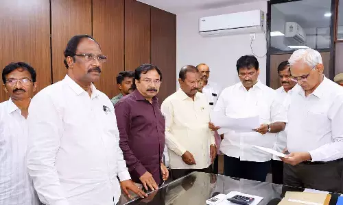APSRTC JAC leaders discussing their demands with executive director (administration) K S Brahmananda Reddy after submitting a representation seeking cancellation of tenders for 1,450 electric buses at RTC House in Vijayawada on Thursday