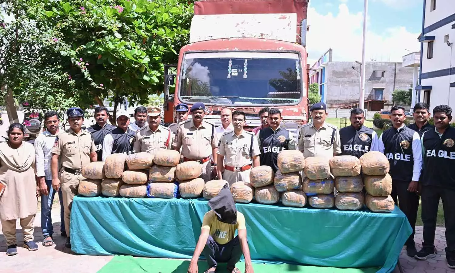 Superintendent of Police Tuhin Sinha and other officials with seized ganja in Anakapalli district on Friday Superintendent of Police Tuhin Sinha and other officials with seized ganja in Anakapalli district on Friday