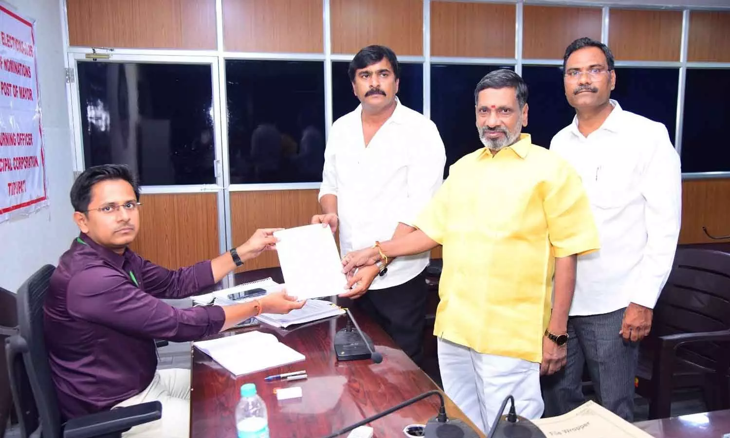 YSRCP candidate Vasu Yadav submitting his nomination papers for the Tirupati Municipal Corporation Mayor post to the Returning Officer at the Municipal Corporation office on Saturday YSRCP candidate Vasu Yadav submitting his nomination papers for the Tirupati Municipal Corporation Mayor post to the Returning Officer at the Municipal Corporation office on Saturday