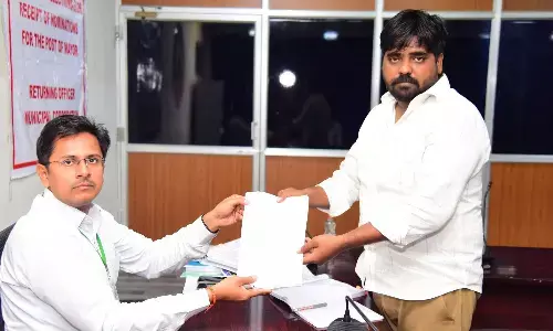 YSRCP candidate Vasu Yadav submitting his nomination papers for the post of mayor to the Returning Officer at the Municipal Corporation office in Tirupati on Sunday