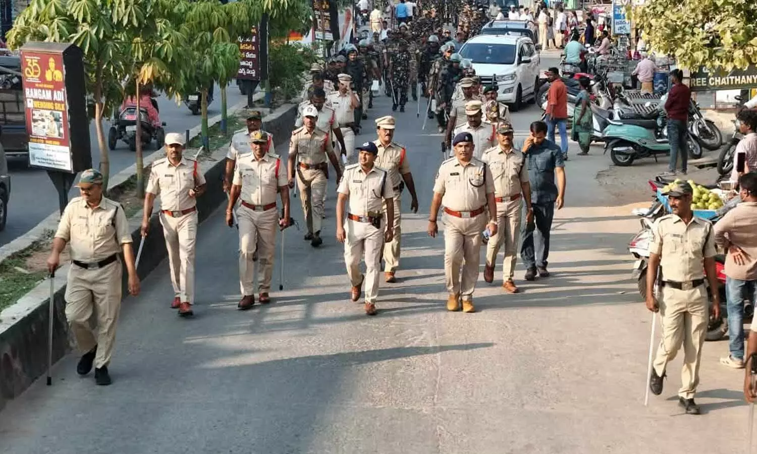 SP S Satish Kumar and police personnel participating in the flag march at Dharmavaram on Friday SP S Satish Kumar and police personnel participating in the flag march at Dharmavaram on Friday