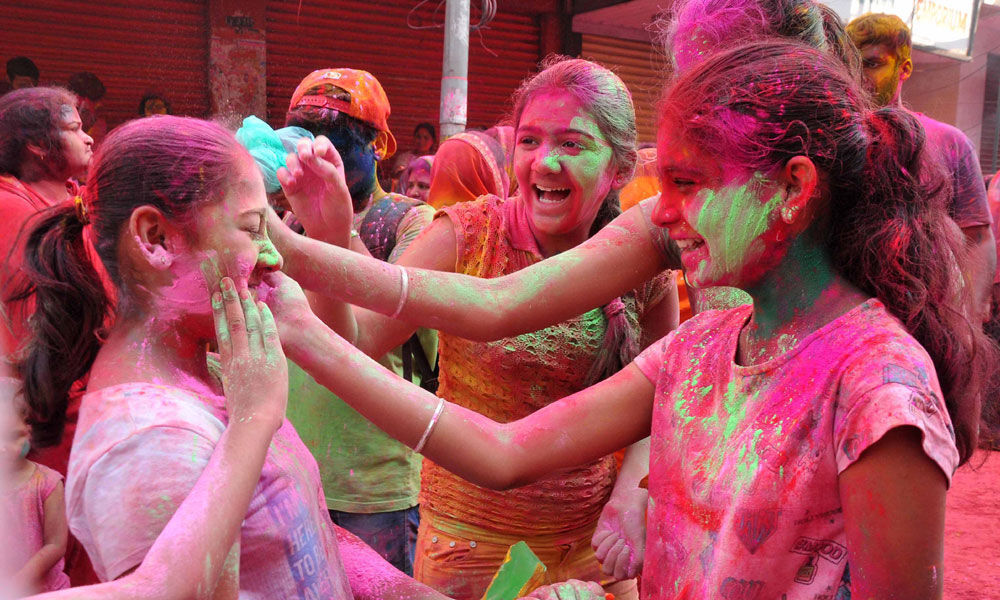 People celebrating Holi festival in the city