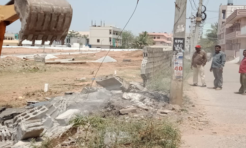 Illegal compound wall demolished